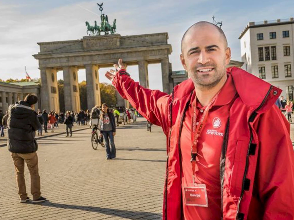 Ein Tourguide vor dem Brandenburger Tor.